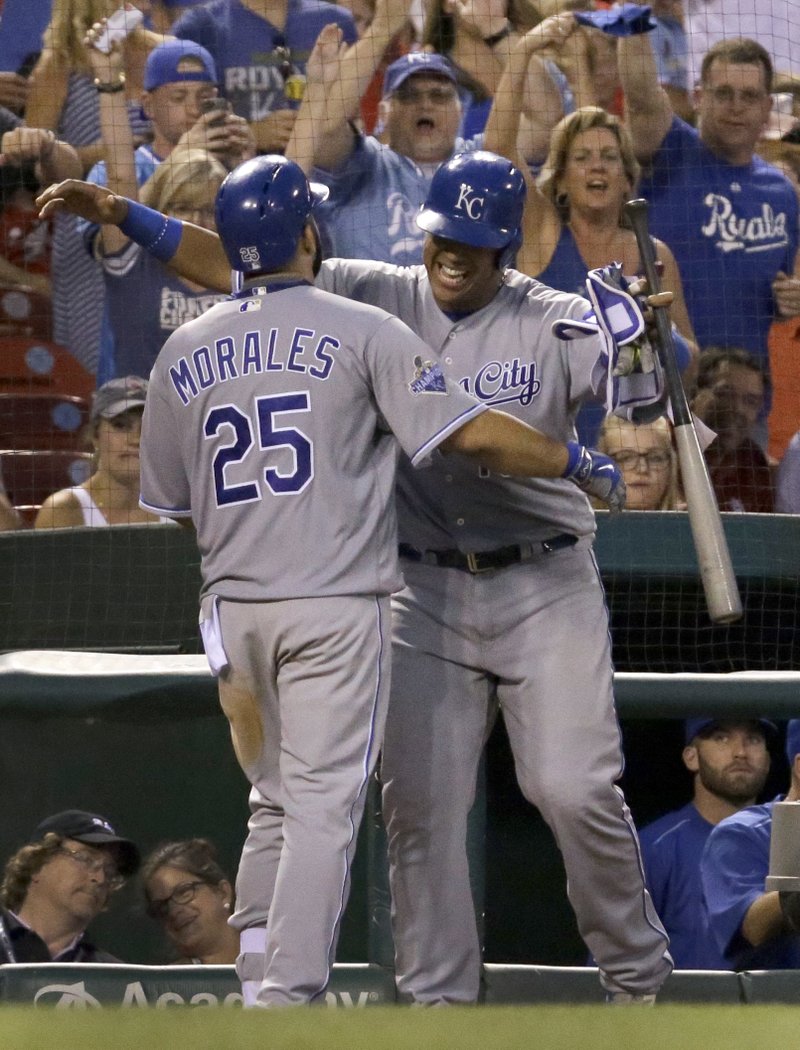 Kansas City Royals' Kendrys Morales, left, gets a hug from Salvador Perez after hitting a solo home run during the eighth inning of a baseball game against the St. Louis Cardinals Thursday, June 30, 2016, in St. Louis. 