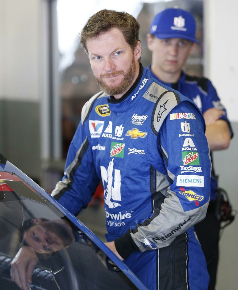 Dale Earnhardt Jr. prepares to get into his car before the start of a NASCAR Sprint Cup auto racing practice at Daytona International Speedway, Thursday, June 30, 2016, in Daytona Beach, Fla. 
