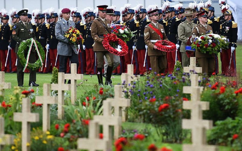 Soldiers place wreaths at graves Friday at the Thiepval World War I cemetery in northern France during a commemoration service on the 100th anniversary of the Battle of the Somme. 