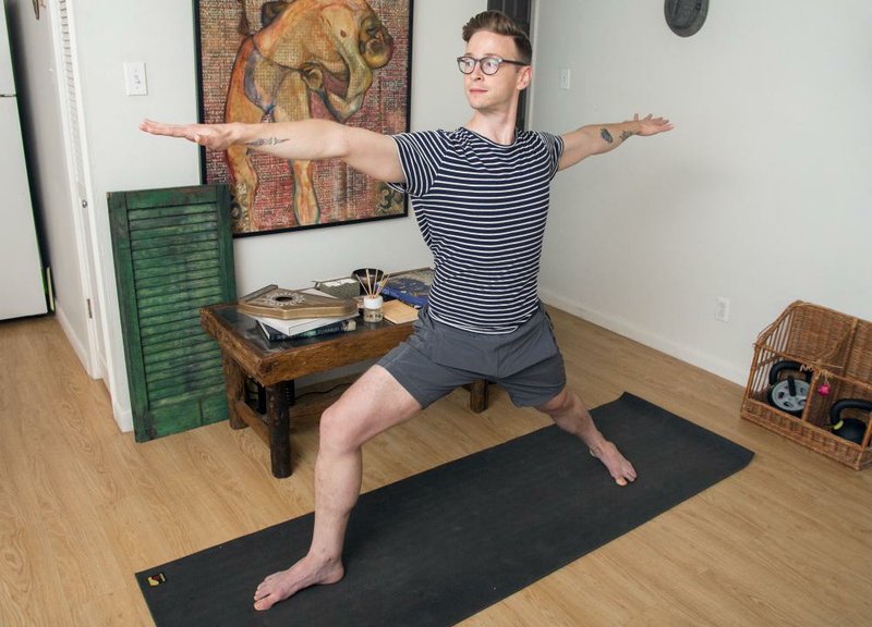 John Willis is shown in his favorite space, his living room, which can quickly be converted into a space that’s dedicated to yoga.