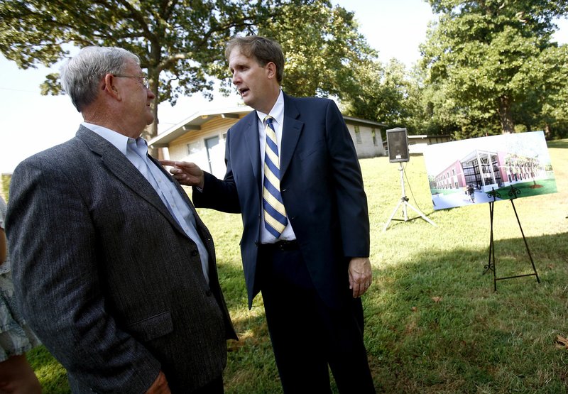 Former Siloam Springs mayor Moose Van Poucke (left) speaks Aug. 16, 2010, with John Brown University President Chip Pollard following a groundbreaking ceremony for the Siloam Springs school’s Engineering/Construction Management facility. Van Poucke died Thursday at 82.