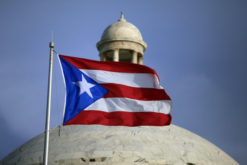  In this July 29, file 2015 photo, the Puerto Rican flag flies in front of Puerto Rico's Capitol as in San Juan, Puerto Rico.