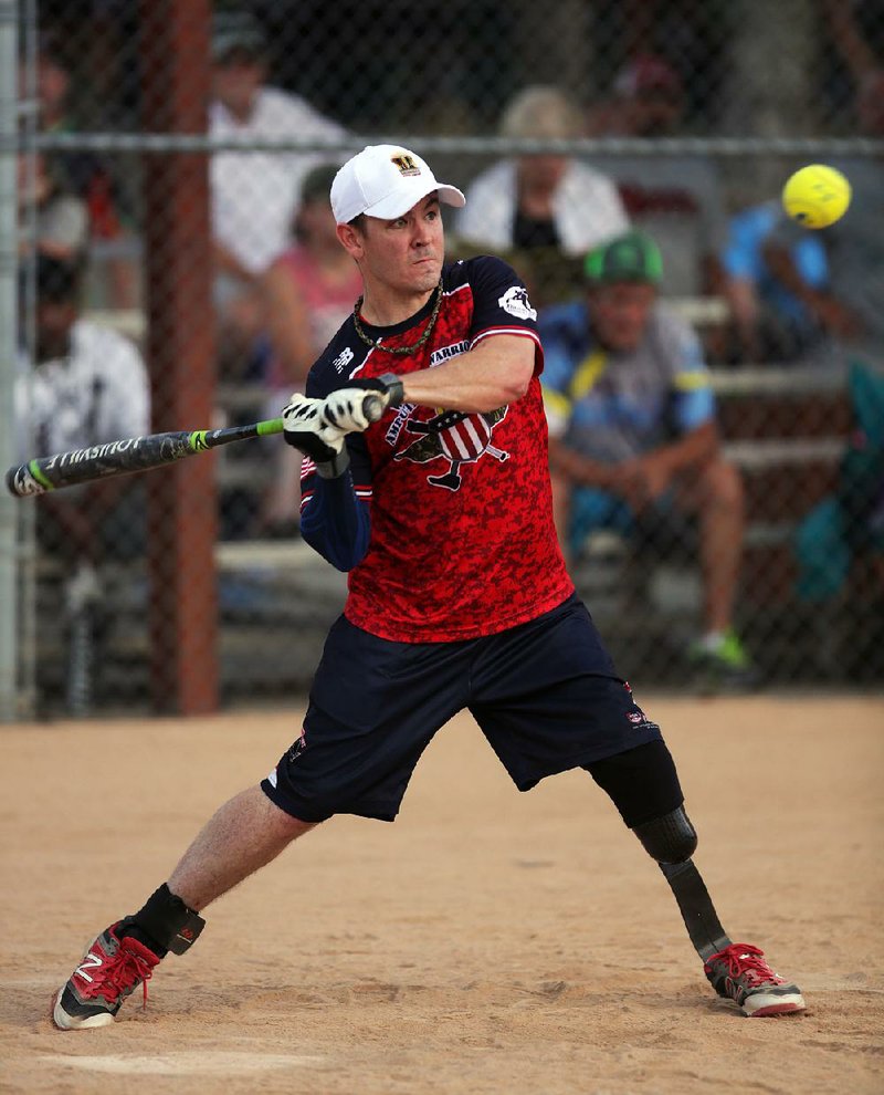 Tim Horton of the Wounded Warriors Amputee Softball Team make contact during their exhibition game Friday, July 1, 2016. Branch of service: Marines