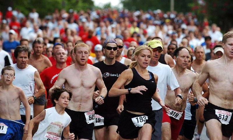 Runners make the turn from North University Avenue onto Kavanagh Boulevard during the 32nd Firecracker Fast 5K in 2008. The 40th Firecracker Fast 5K, which is scheduled to begin at 7:30 a.m. Monday in Little Rock, is showing a steady increase in the number of female runners, which re•ects a national trend. “There are more runners than ever right now, and that’s mostly because of women,” said veteran marathoner Bill Rodgers, who won multiple races in Boston and New York, and ran in the Firecracker several times in previous years.