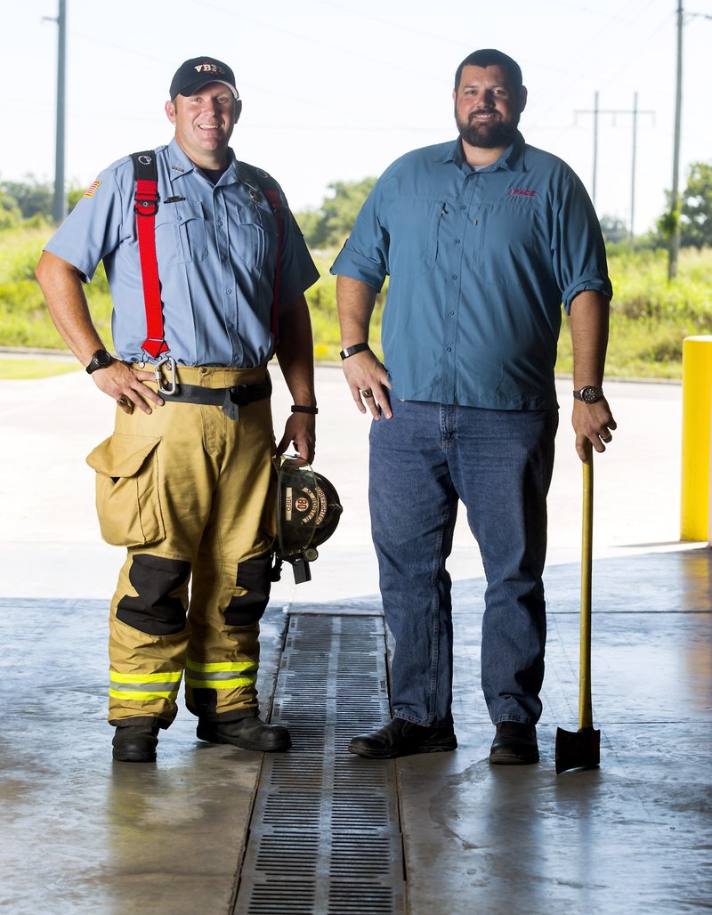 Michael Boster (left), now a fireman in Van Buren, and Kenny Sandlin, who formerly worked as a fireman in Bentonville and Lowell, are pictured recently. 