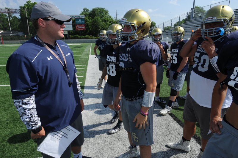 Former Shiloh Christian standout Josh Salsbury (left) speaks to players June 15 while participating in a camp at Jarrell Williams Bulldog Stadium. Salsbury was a four-year starter at center for Shiloh Christian starting in 2006. 