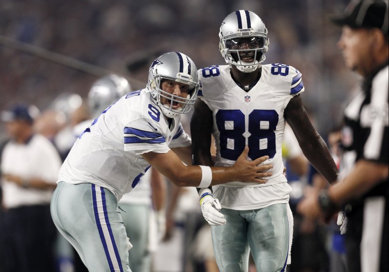 Dallas quarterback Tony Romo (left) and wide receiver Dez Bryant react during the first half of a game against the New York Giants last season in Arlington, Texas. Both are anxious to get back on the field together after injuries kept them apart most of last season, which hurt the Cowboys in their quest to return to the playoffs.