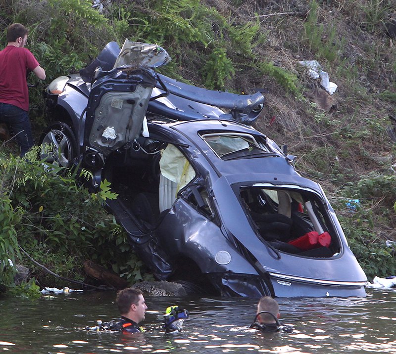 A car is pulled from Lake Hamilton after a wreck Sunday.