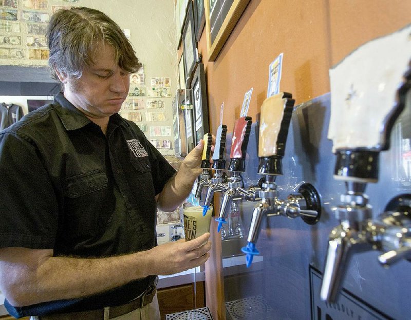 Ian Beard fills a glass in Stone’s Throw Brewing’s Rock Street tap room.