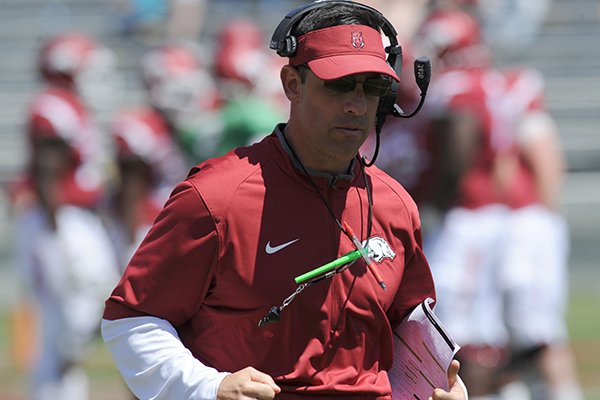 Arkansas offensive coordinator Dan Enos works with his players Saturday, April 23, 2016, during the annual spring Red-White game in Razorback Stadium. 