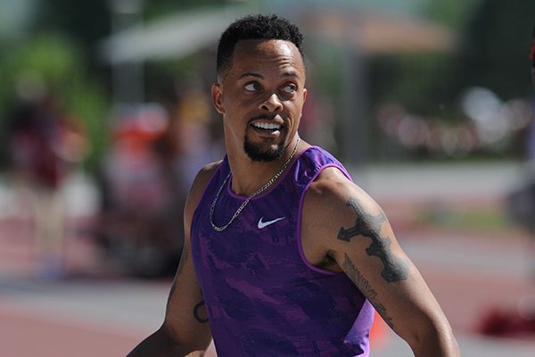 Former Fayetteville High and Arkansas sprinter Wallace Spearmon checks out the scoreboard Saturday, April 23, 2016, after his finish in the 100 meters during the John McDonnell Invitational at John McDonnell Field in Fayetteville. 