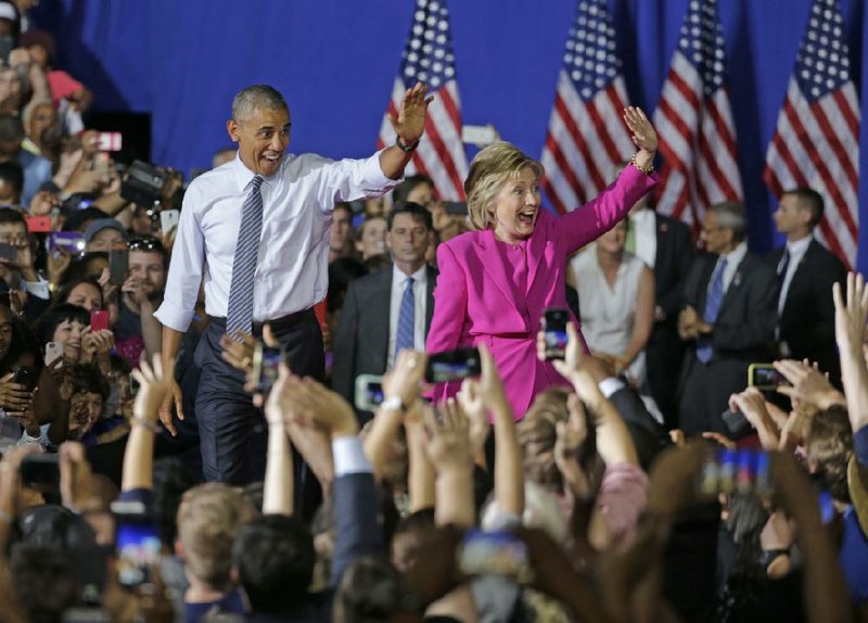 President Barack Obama and Hillary Clinton bid the crowd farewell Tuesday after a campaign rally in Charlotte, N.C. “There has never been any man or woman more qualified” to be president, Obama said. 