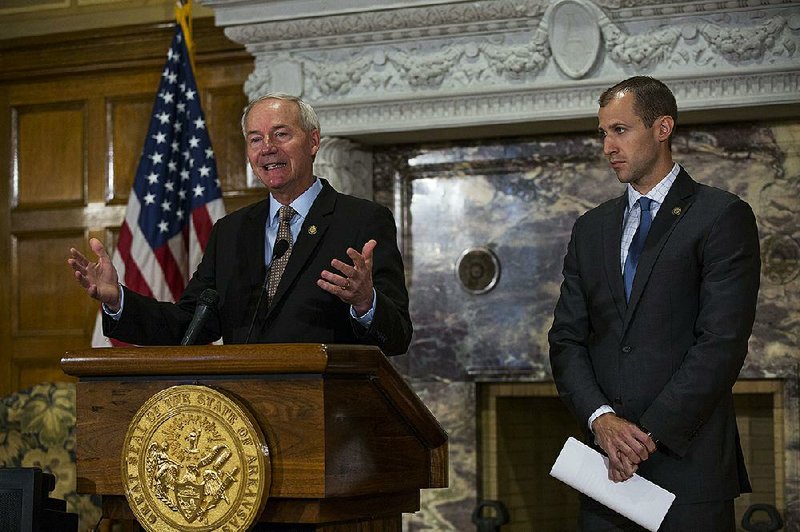 Gov. Asa Hutchinson (left), and Mike Preston, executive director of the Arkansas Economic Development Commission, discuss the state’s upcoming trip to the Farnborough International Airshow outside London. Arkansas is beefing up its European presence including opening an office in Germany. 