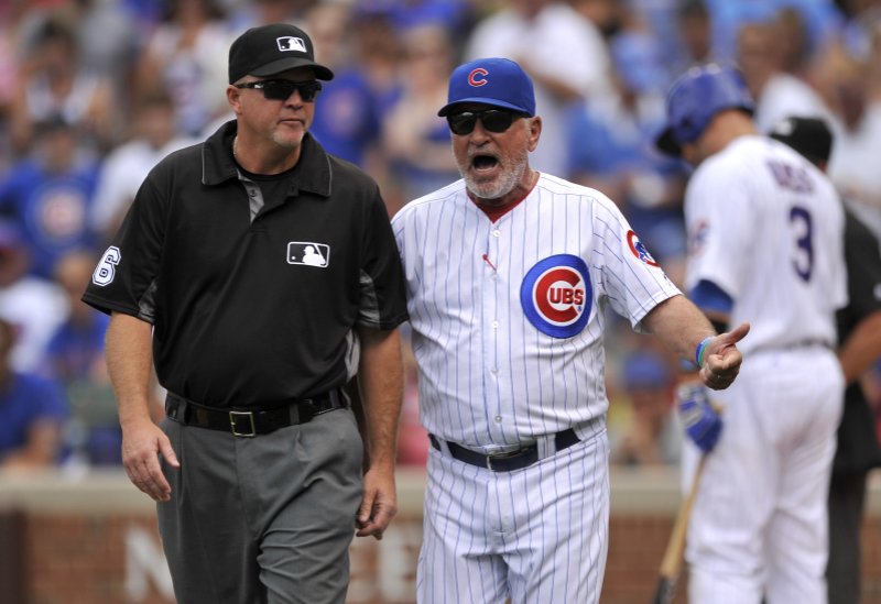 Chicago Cubs manager Joe Maddon, right, argues with second base umpire Ron Kupla, left, after Maddon was ejected by home plate umpire Jerry Meals while Maddon was arguing a strike call on Cubs' David Ross during the second inning of a baseball game against the Cincinnati Reds, Tuesday, July 5, 2016, in Chicago. 