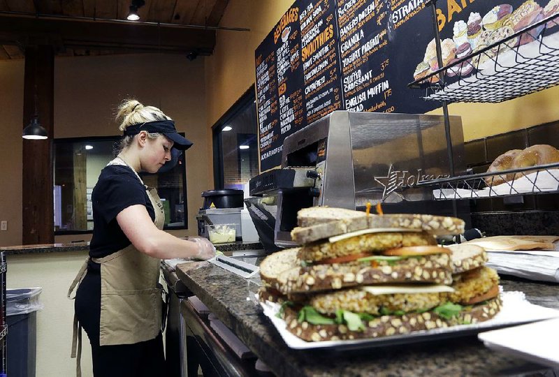 An employee at Good Day Cafe in North Andover, Mass., makes sandwiches in this file photo. U.S. services firms expanded last month at the fastest pace since November, the Institute for Supply Management said Wednesday. 