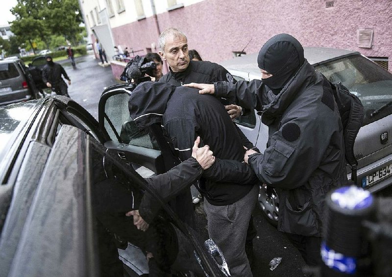 French police detain a suspect during a raid on May 13, 2014, in Strasbourg that netted some of the men convicted Wednesday of terror charges. 
