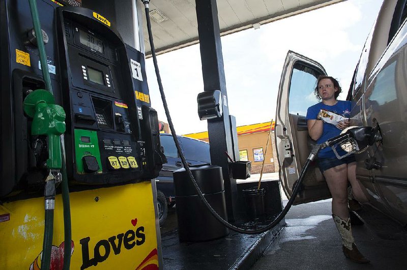 Niki Bruner pumps gas Wednesday at a Love’s station in North Little Rock.
