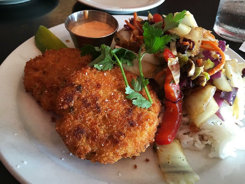 Crab Cakes, “Lilly’s crowd favorite,” come with sauteed mixed vegetables, chili aioli and rice.
