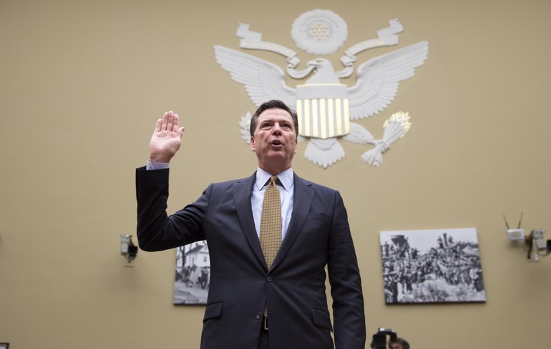 FBI Director James Comey is sworn in on Capitol Hill in Washington, Thursday, July 7, 2016, prior to testifying before the House House Oversight and Government Reform Committee hearing to explain his agency's recommendation to not prosecute Democratic presidential candidate Hillary Clinton over her private email setup. (AP Photo/J. Scott Applewhite)
