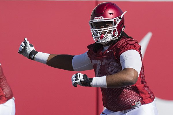 Arkansas offensive lineman Deion Malone goes through drills Tuesday, March 29, 2016, at the Razorbacks' practice field in Fayetteville. 