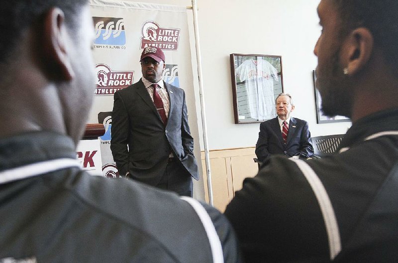 The first nonconference schedule for Wes Flanigan (center) as UALR’s men’s basketball coach is a 13-game slate that includes six home games and five games against in-state schools.