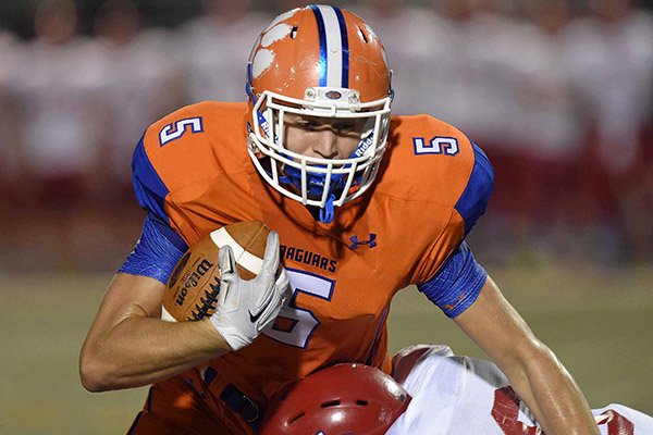 Madison Central's Grayson Gunter (5) is tackled by Warren Central defender Byron Galvin on Friday, Oct. 9, 2015, at Madison Central High School in Madison, Miss.