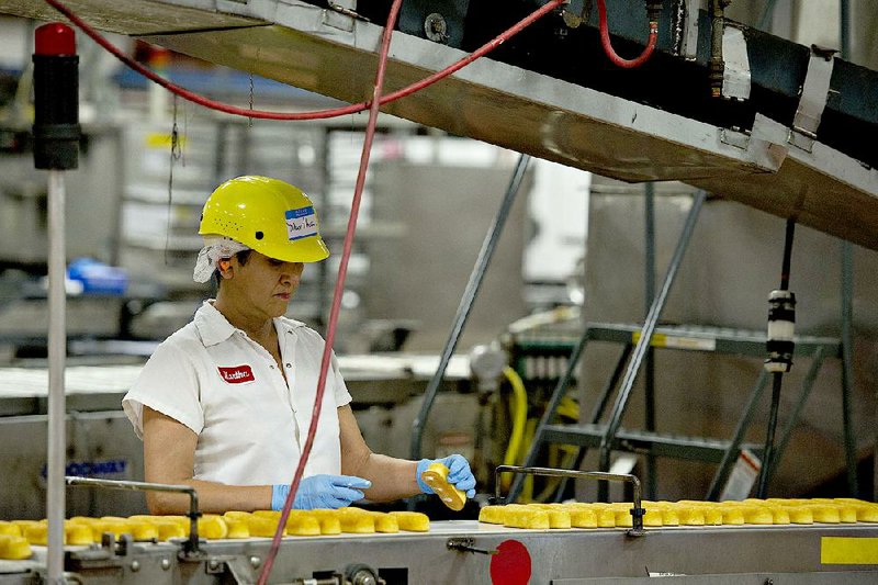 An employee inspects freshly baked Twinkies snack cakes at a Hostess Brands LLC bakery in Schiller Park, Ill.