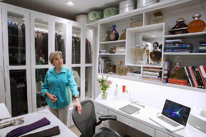 Sue Price converted the dining room of her new condo into a luxurious closet. She included a work area with a desk.