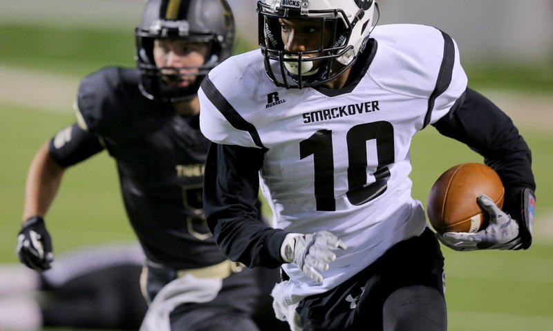 Smackover's Jordan Jones runs in a pass for their second TD in the first quarter during their 3A state championship football game Friday night at War Memorial Stadium in Little Rock. Charleston vs. Smackover.