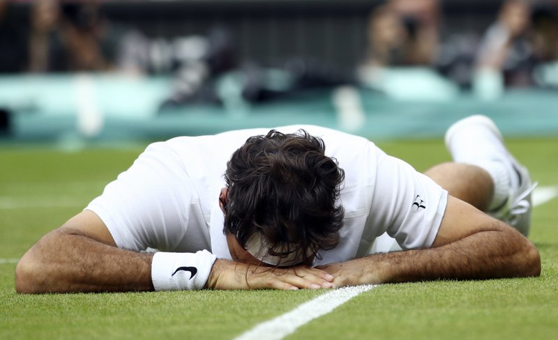 The Associated Press FED EXED: Roger Federer falls over during his Wimbledon men's semifinal singles match against Milos Raonic Friday in London. Raonic won 6-3, 6-7 (3), 4-6, 7-5, 6-3, advancing to his first Grand Slam final.