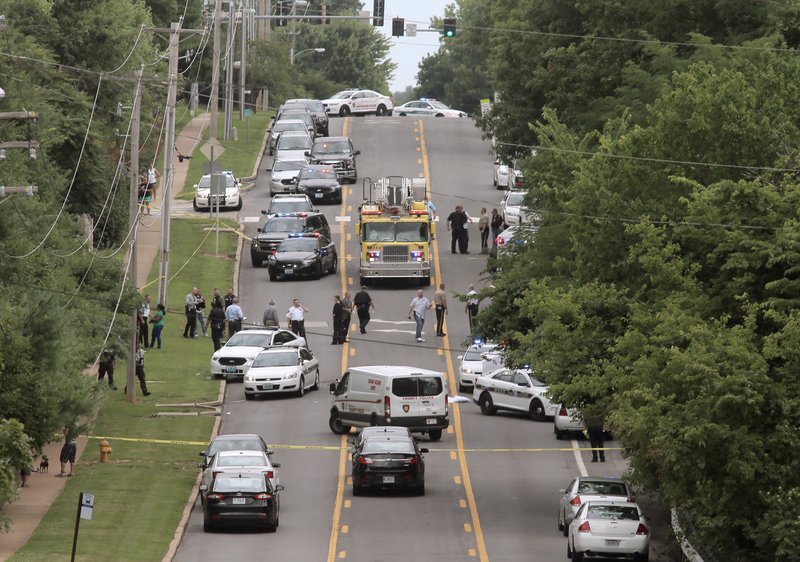 Police investigate a scene in Ballwin, Mo., after a Ballwin police officer was shot during a confrontation with a man on a street. Authorities say the wounded police officer is hospitalized but didn’t offer any immediate word about the officer’s medical status. A suspect is in custody, and a handgun has been recovered. 