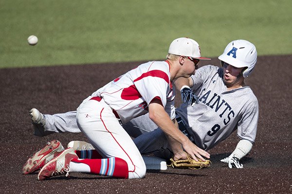 St. Thomas Aquinas base runner Blake Lillis was safe at second base after Shawnee Heights infielder Caleb Schiefelbein missed the ball during Kansas Class 5A baseball state tournament championship game Saturday, May 28, 2016.