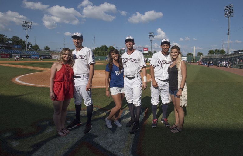 Megan and Matt Strahm (from the left) Maddi and Logan Moon, and Mauricio and Kylee Ramos pose behind the plate after a Naturals game June 19 at Arvest Ballpark.