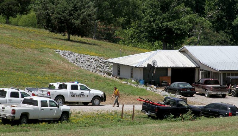Garland County sheriff’s deputies and other first responders arrive Sunday at Lost Springs Ranch in Mountain Pine, where a 4-yearold boy was struck and killed by a mower.