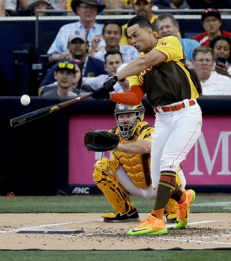Miami Marlins outfielder Giancarlo Stanton, playing for the National League squad, hits one of his record 61 home runs during the major league baseball All-Star Home Run Derby on Monday in San Diego.
