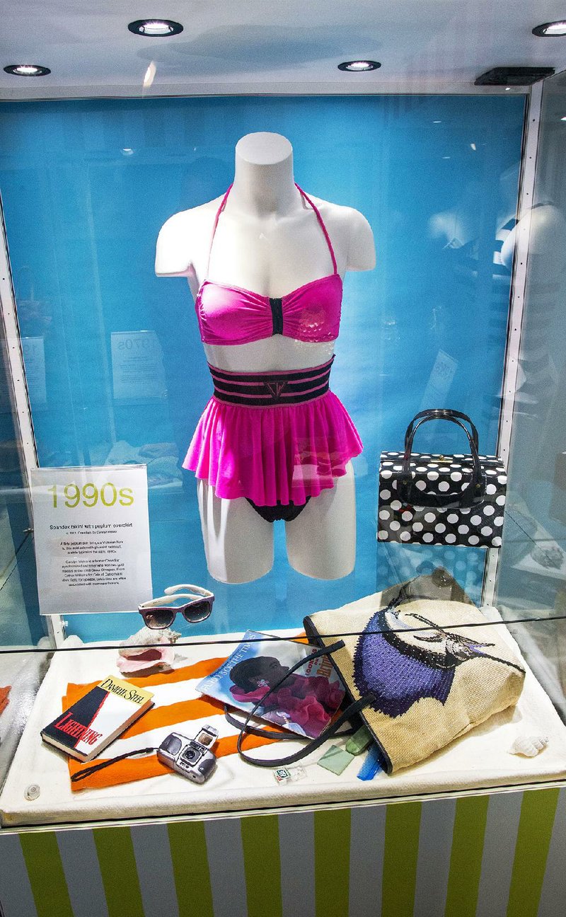 Neon colors and flirty peplum skirts graced women’s swimwear of the 1990s, as seen in the temporary exhibit, “Changing Tides: 100 Years of Iconic Swimwear,” on display at the Esse Purse Museum in Little Rock through Aug. 7.