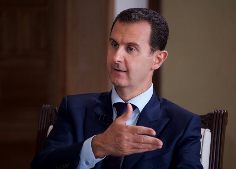 In this file photo released on July 1, 2016, by the Syrian official news agency SANA, Syrian President Bashar Assad speaks during an interview with Australia's SBS news channel, in Damascus, Syria. 