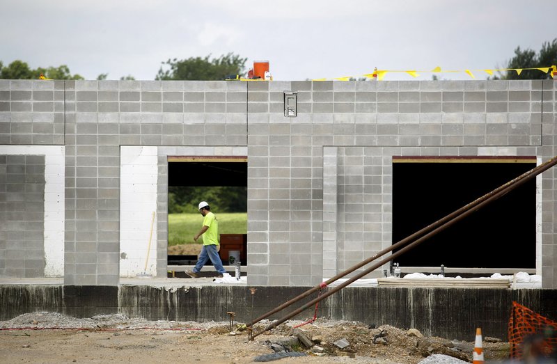 Construction continues Monday on the former Tyson Foods plant at 801 SE Eighth St. in Bentonville.