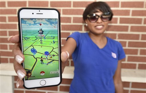 Keyanna Arnett poses for a photo with the Pokémon Go game on her cellphone at Augusta University in Augusta, Ga., on Tuesday, July 12, 2016