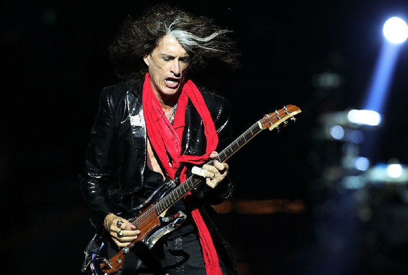 In this Saturday, May 25, 2013 file photo, lead guitarist Joe Perry, of American rock band Aerosmith, performs in Singapore during the inaugural Social Star Awards concert. 