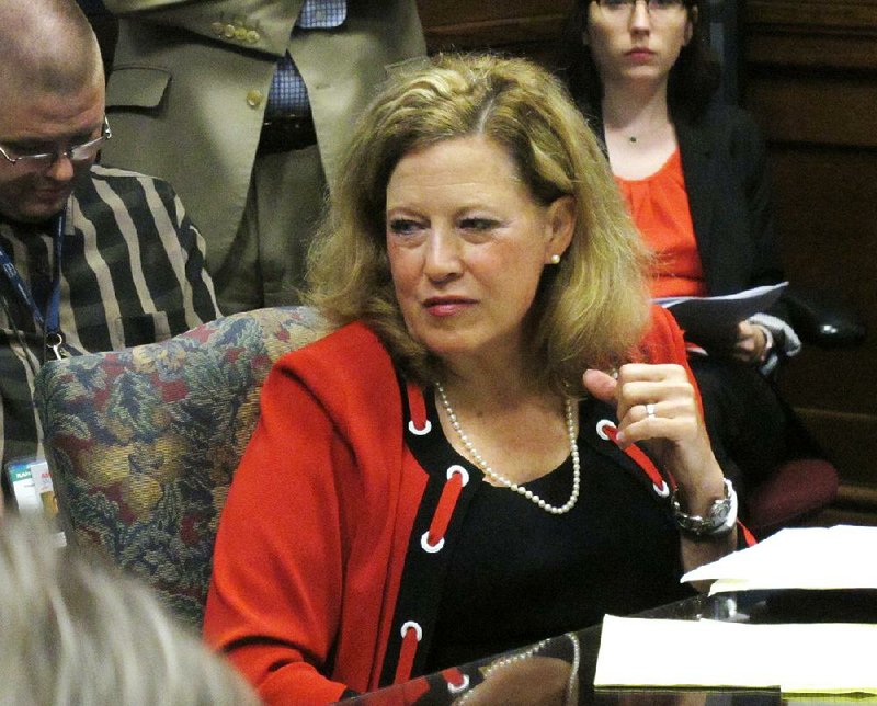 Kansas state Sen. Vicki Schmidt listens Tuesday to comments during a meeting in Topeka, Kan., of a state regulations board before it approved a temporary rule requiring county election officials to throw out votes in state and local races cast by people who haven’t provided proof of their U.S. citizenship. 
