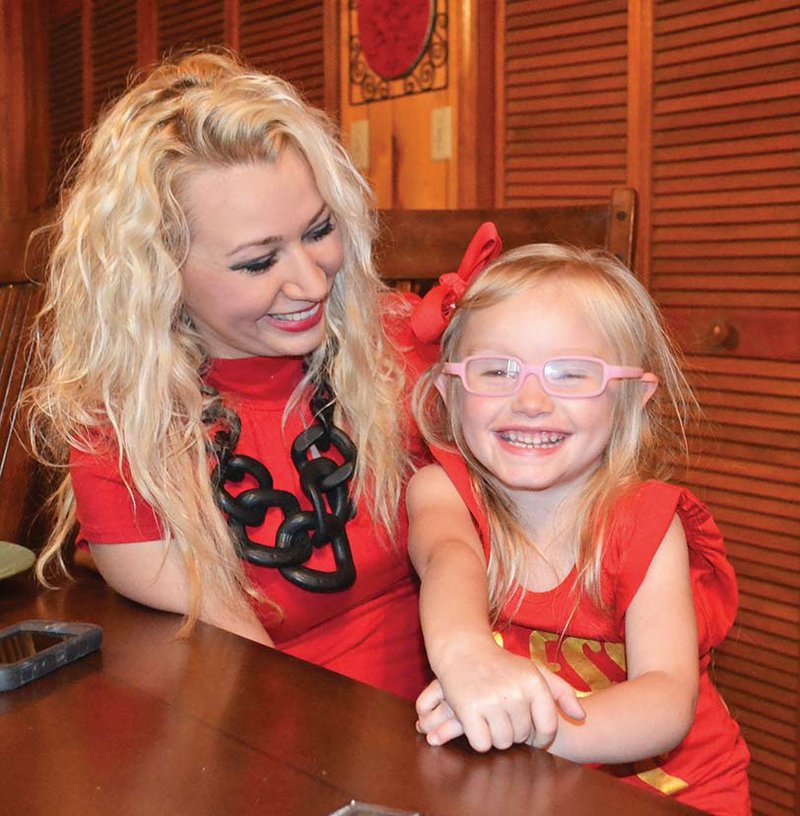 Jami Allen of Russellville poses with her 4-year-old daughter, Adora, who had a stroke shortly after she was born. Allen had no idea that babies could have strokes, and she found information through the Children’s Hemiplegia and Stroke Association, known as CHASA. Allen has become passionate about educating others about pediatric strokes, and she organized a fundraising event in May for the association and plans to help raise more money for research.