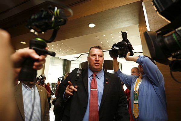 Arkansas coach Bret Bielema walks into a sea of media at the Southeastern Conference NCAA college football media days, Wednesday, July 13, 2016, in Hoover, Ala. (AP Photo/Brynn Anderson)
