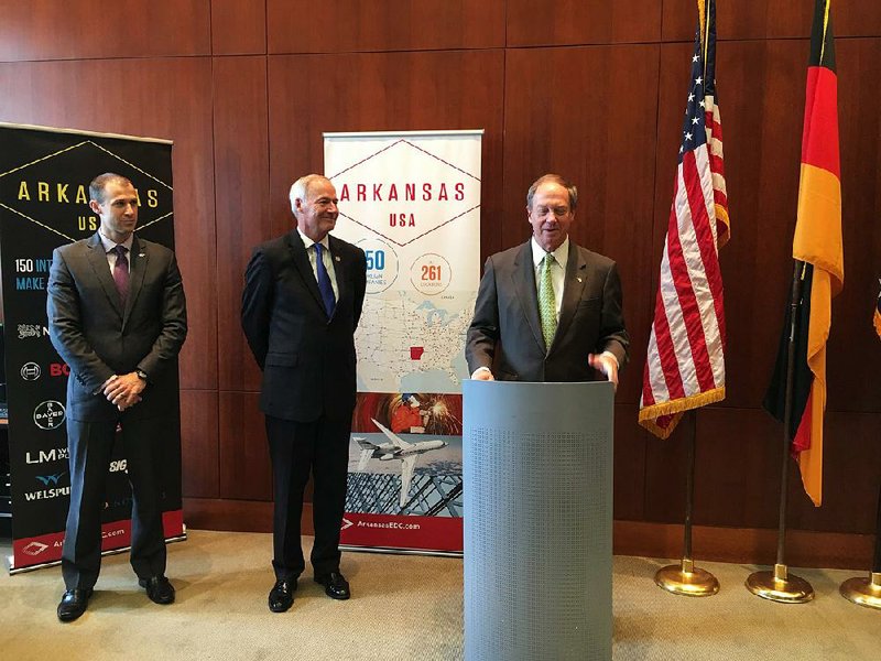 Mike Preston, executive director of the Arkansas Economic Development Commission; Gov. Asa Hutchinson; and U.S. Ambassador to Germany John B. Emerson open an Arkansas economic development office in Berlin on Wednesday. 