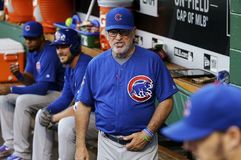 Chicago Cubs manager Joe Maddon stands in the dugout before a baseball game against the Pittsburgh Pirates in Pittsburgh, Friday, July 8, 2016. 