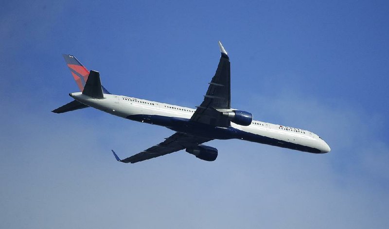 A Delta Air Lines Boeing 757 flies over Seattle, in this March file photo. The airline on Thursday reported second-quarter revenue of $10.45 billion.