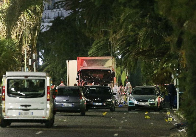 Bullet holes pock the windshield of the white truck that plowed into Bastille Day revelers Thursday in the resort city of Nice in southern France.
