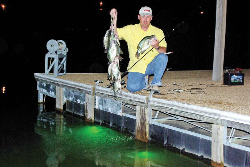 In this file photo Josh Sutton of Wynne poses for a picture with a mess of crappie caught from a Lake Greeson boat dock. 
