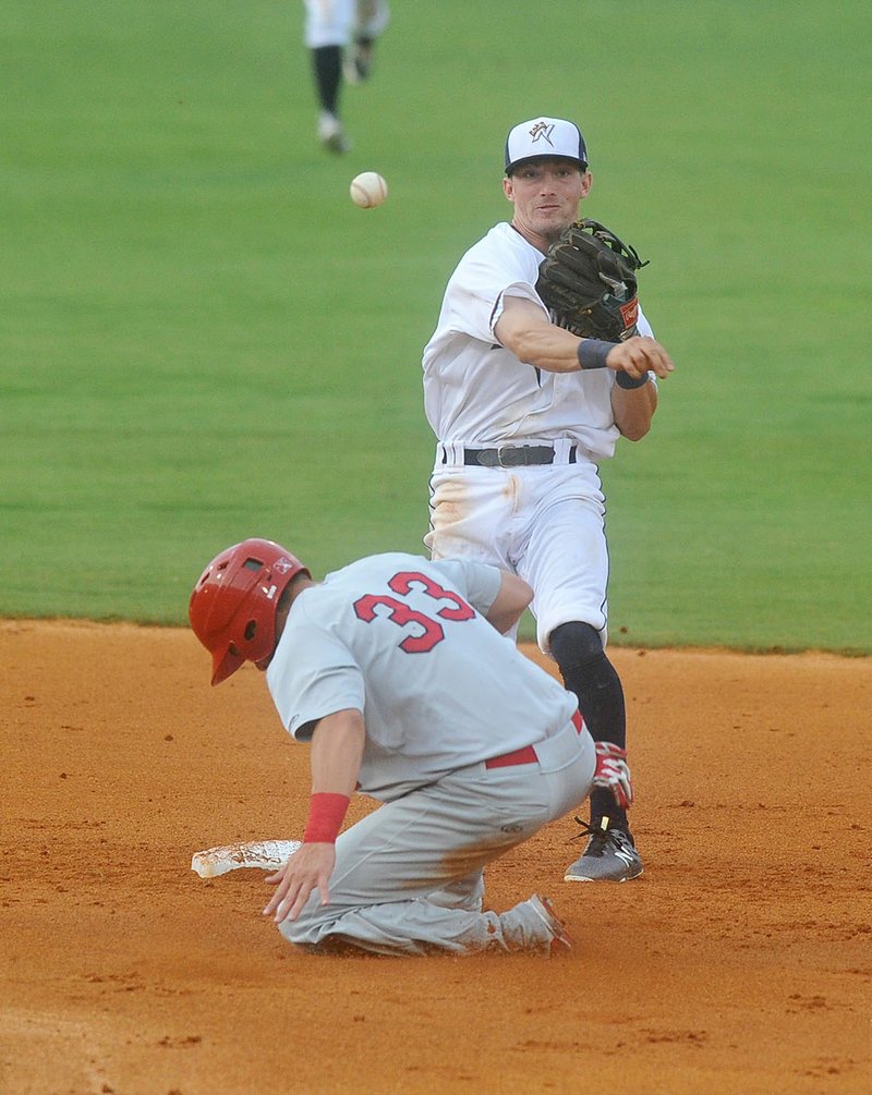 Naturals second baseman Corey Toups forces Springfield baserunner Nick Martini (33) out at second base as he turns a double play Thursday, July 14, 2016 during their game against Springfield at Arrest Ballpark in Springdale.