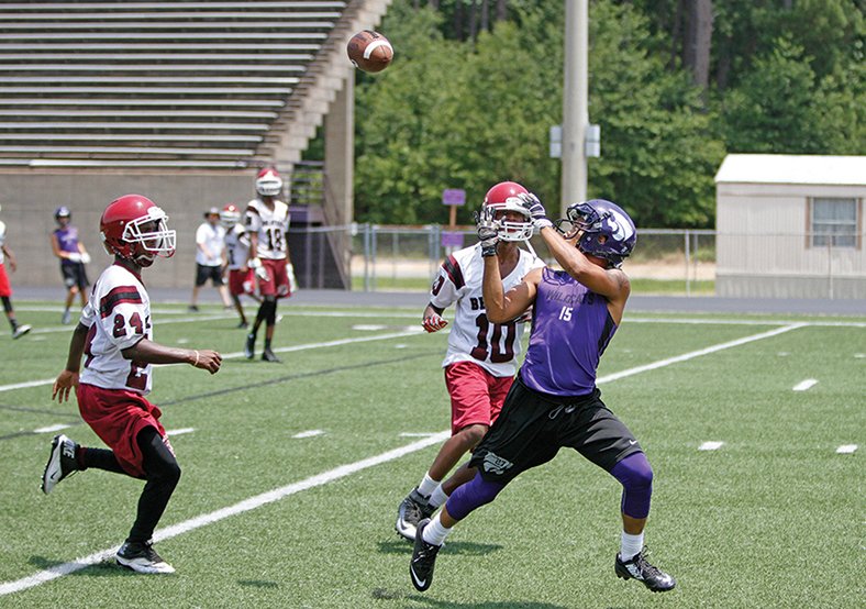 Terrance Armstard/News-Times El Dorado High School's Charles Cage (15) tries to haul in a pass against Lake Village during a 7-on-7 tournament at Memorial Stadium on Friday. Monticello topped El Dorado to win the championship.